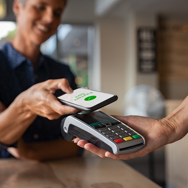 Woman,Paying,Bill,Through,Smartphone,Using,Nfc,Technology,In,A